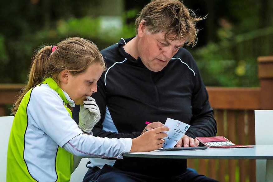 Marking golf scorecards.