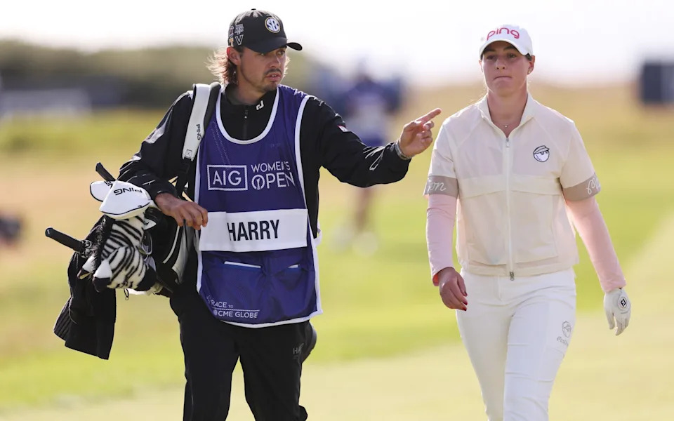 Darcey Harry of Wales interacts with her caddie, Jacob Skov Olesen, on the 18th hole during the first round of the AIG Women's Open