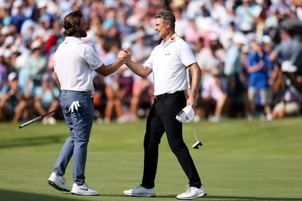 Justin Rose of England shakes hands with Tommy Fleetwood of England on the 18th hole green after finishing the final round of the FedEx St. Jude Championship 2025 at TPC Southwind on August 10, 2025 in Memphis, Tennessee.