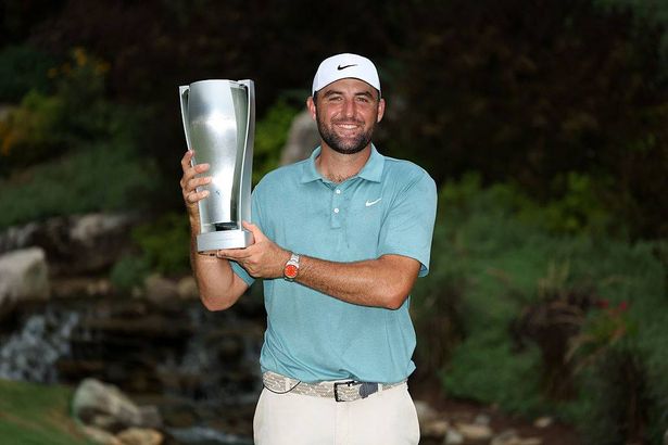 Scottie Scheffler of the United States poses with the tournament trophy after his winning round on the 18th green after the final round of the BMW Championship 2025