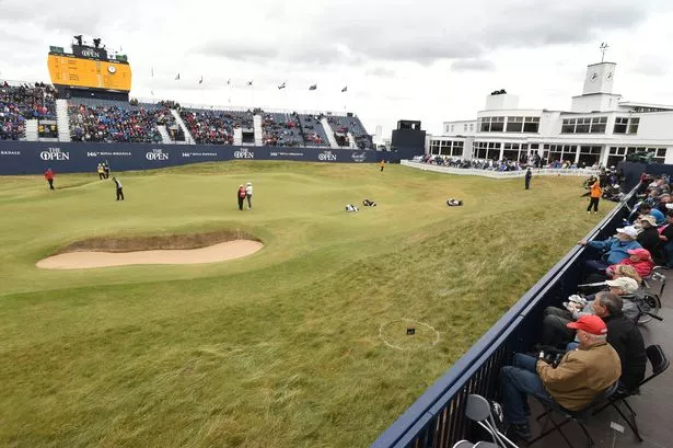 Golfers on the 18th Green alongside the Art Deco clubhouse. at Royal Birkdale. The Open Championship 2017