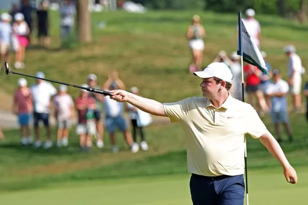 Robert MacIntyre reacts after putting on the 14th