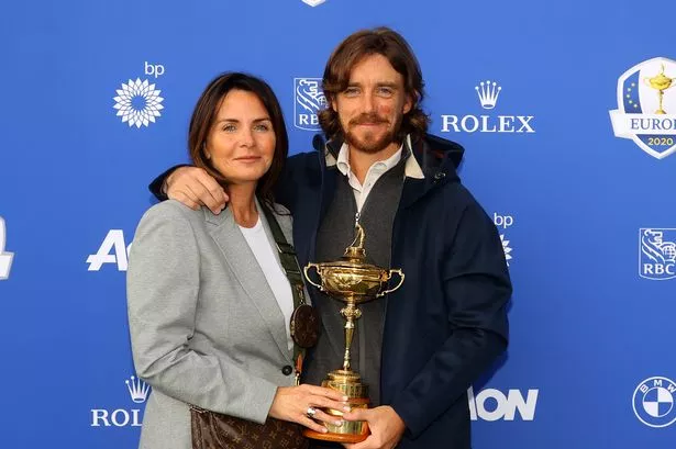 Tommy Fleetwood and his wife Clare pose with the Ryder Cup trophy