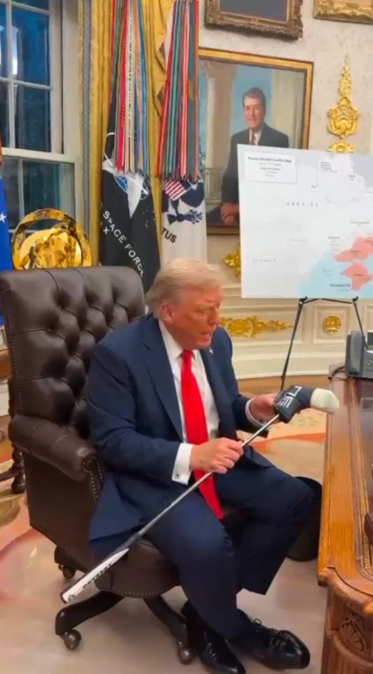 President Trump holding a golf club gifted by President Zelensky.