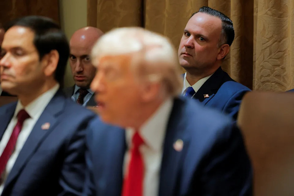 Dan Scavino (R) looks on during a cabinet meeting in February, along with Stephen Miller. Scavino met Trump when he was a caddy in Westchester County, New York, in the early 90s.  / Brian Snyder / REUTERS