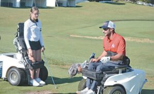 Adaptive Golf Clinic instructor Jimmy Moceri works with adaptive athlete and golfer Allison Thurman during the McLaren Adaptive Golf Clinic held at Warwick Hills’ driving range and putting green on Monday.
