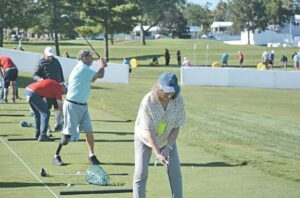 Adaptive athletes hit golf balls on the driving range during Monday’s McLaren Adaptive Golf Clinic held at Warwick Hills’ driving range and putting green on Monday.