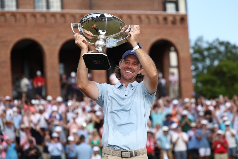 Tommy Fleetwood celebrates with the Fedex Cup trophy 