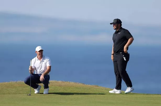 Rory McIlroy and Chris Gotterup prepare to putt