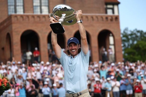 Tommy Fleetwood holding up the Tour Championship trophy