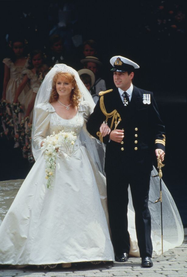 British Royals Sarah, Duchess of York, wearing an ivory-silk Lindka Cierach wedding dress, and Prince Andrew, Duke of York, wearing the ceremonial uniform of a Royal Navy lieutenant, arm-in-arm following their wedding ceremony at Westminster Abbey in London, England, 23rd July 1986. 