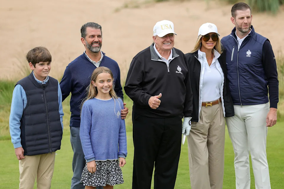 President Donald Trump stands with Donald Trump Jr. (2nd L), Lara Trump (2nd R) and Eric Trump and family at the ribbon-cutting ceremony at a new 18-hole course at Trump International Golf Links on July 29, 2025 in Balmedie, near Aberdeen, Scotland.