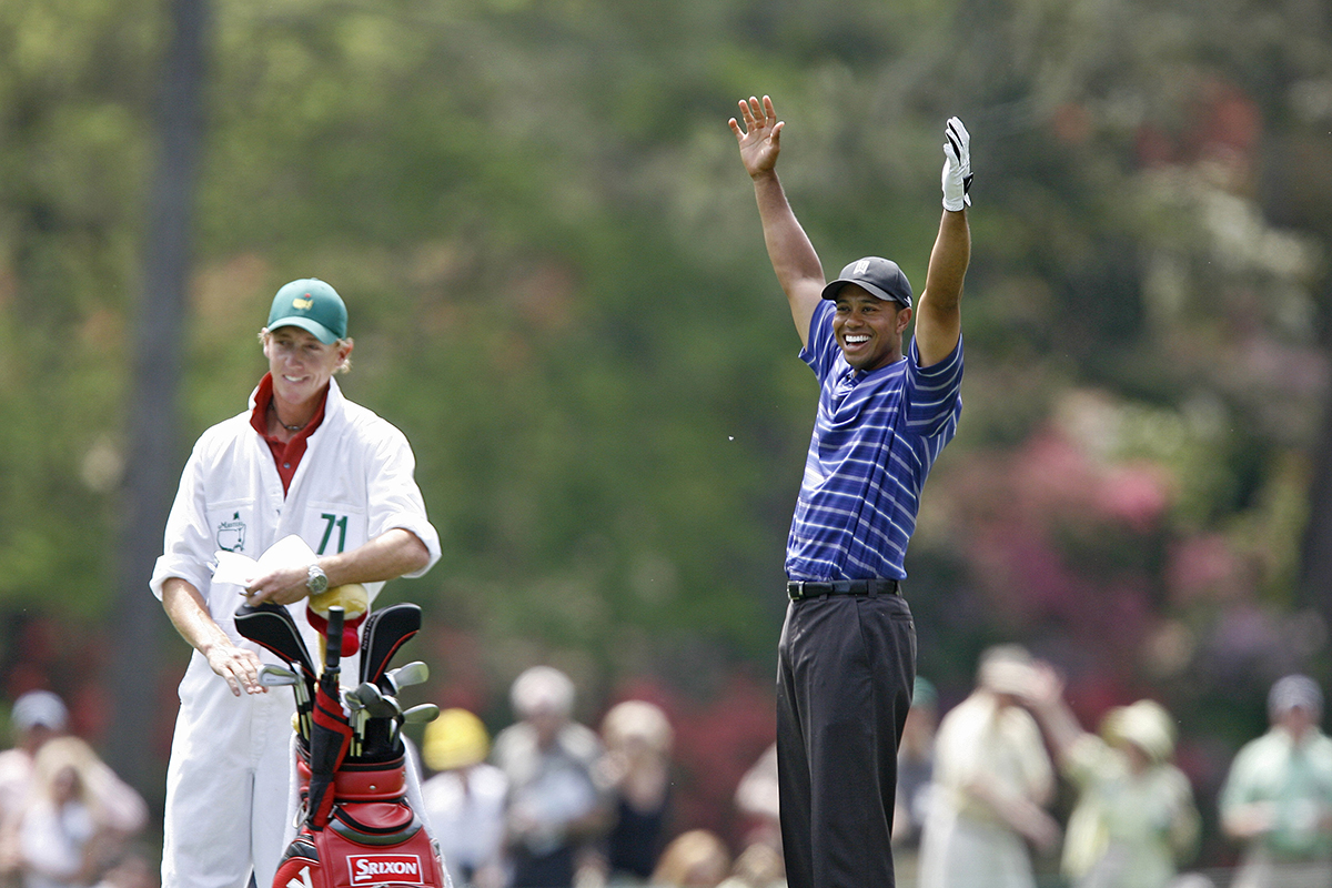 Tiger Woods celebrating a hole-out eagle on the 14th hole during the first round of The Masters at Augusta National