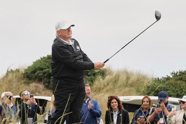 President Donald Trump tees off during the opening ceremony for...