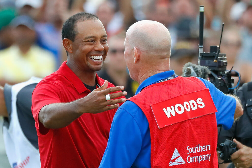 Tiger Woods of the United States celebrates winning the Tour Championship with his caddie
