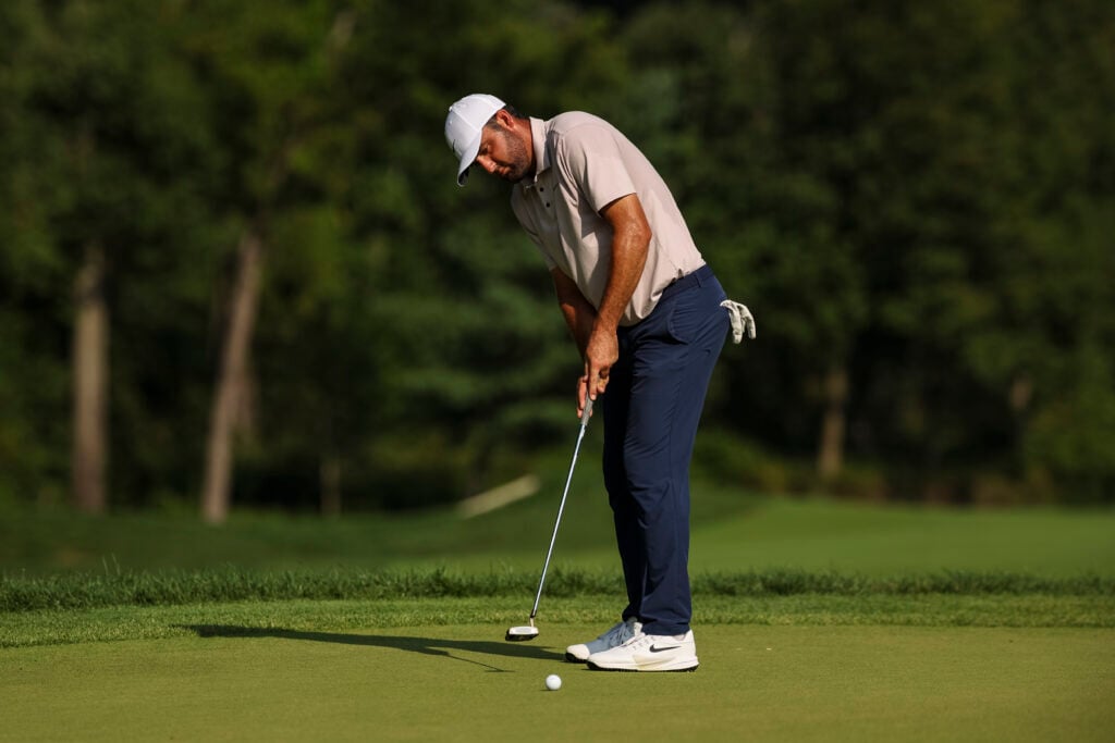 Scottie Scheffler hits a putt during the third round at the BMW Championship