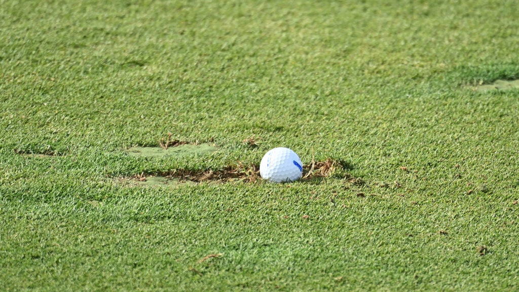 Golf ball in divot hole