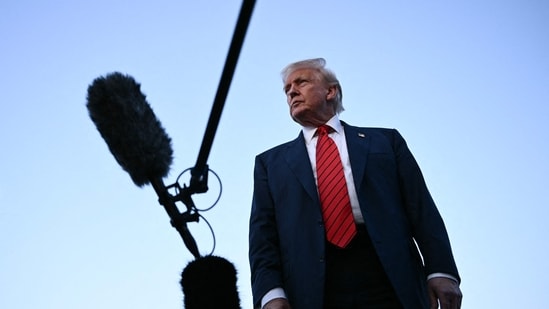US President Donald Trump speaks to journalists at Lehigh Valley International Airport in Allentown, Pennsylvania, as he returns to the White House from his Bedminster residence, where he spent the weekend.(AFP)