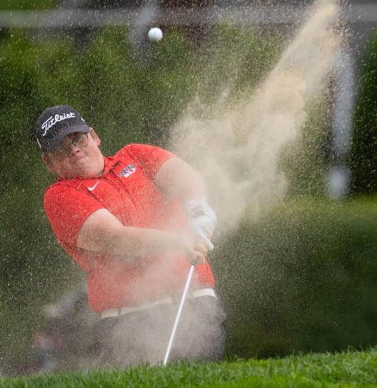 Lackawanna Trail's Grady June takes a shot from the bunker during a match against Riverside last season. EXAMINER FILE PHOTO