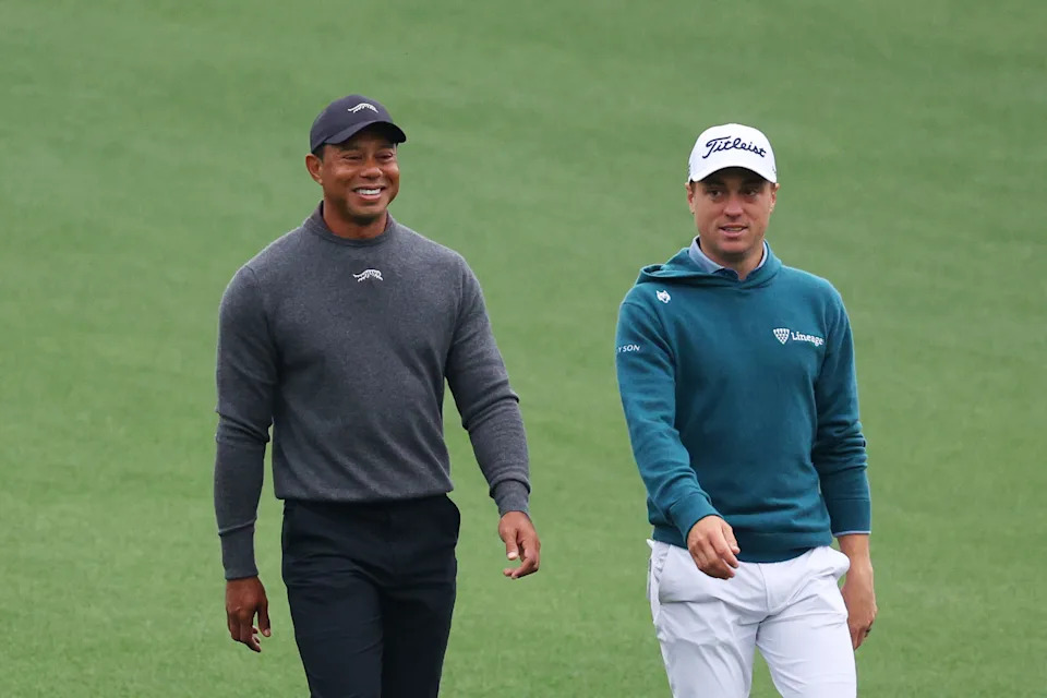 Tiger Woods of the United States and Justin Thomas of the United States walk down the first fairway during a practice round prior to the 2024 Masters Tournament at Augusta National Golf Club on April 09, 2024 in Augusta, Georgia.