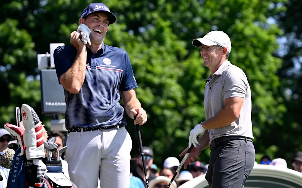 Keegan Bradley (left) shares a light moment with Rory McIlroy as they start the first round of the Travelers Championship at TPC River Highlands in June