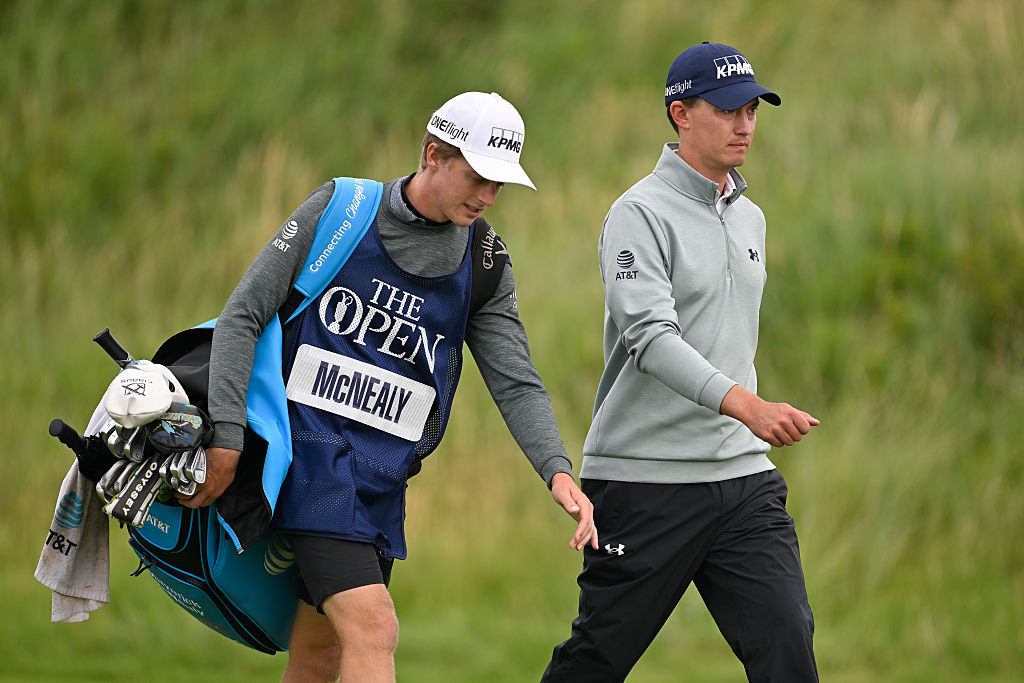 Maverick McNealy walking alongside his caddie who is carrying his bag during at The Open Championship