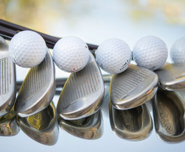 Golf clubs lined up in a row