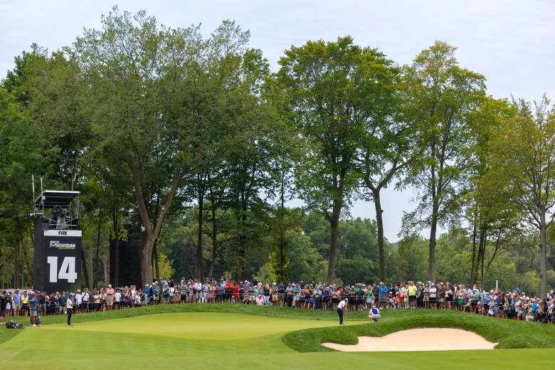 Crowds surround the putting green.