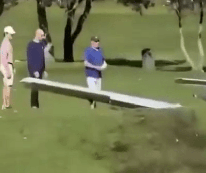 Small plane crash-landing on a golf course.