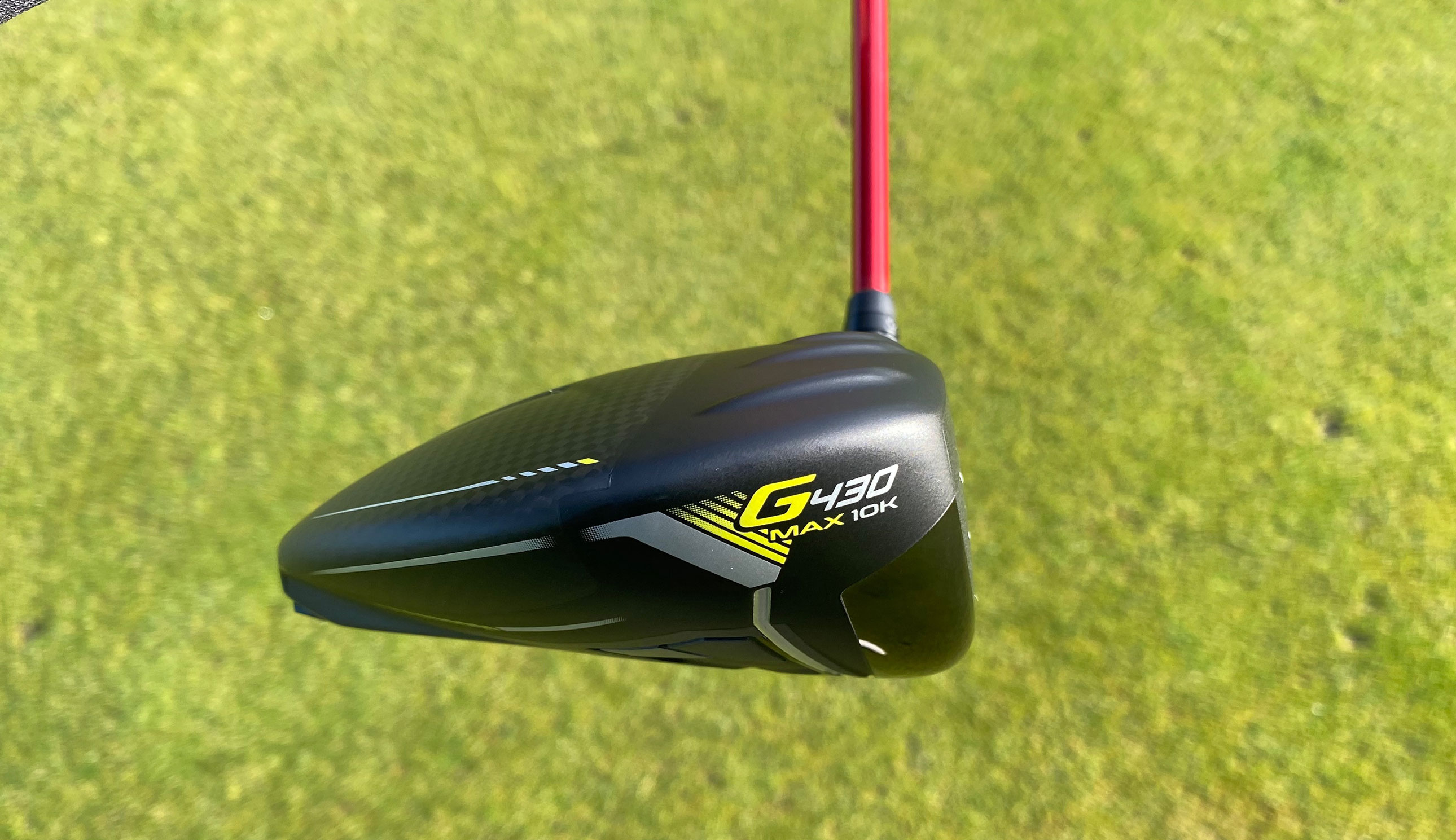 The toe of the Ping G430 Max 10K Driver with a green background
