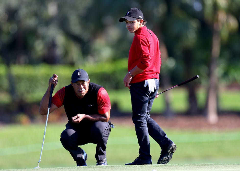tiger lining up a putt while playing with son charlie woods
