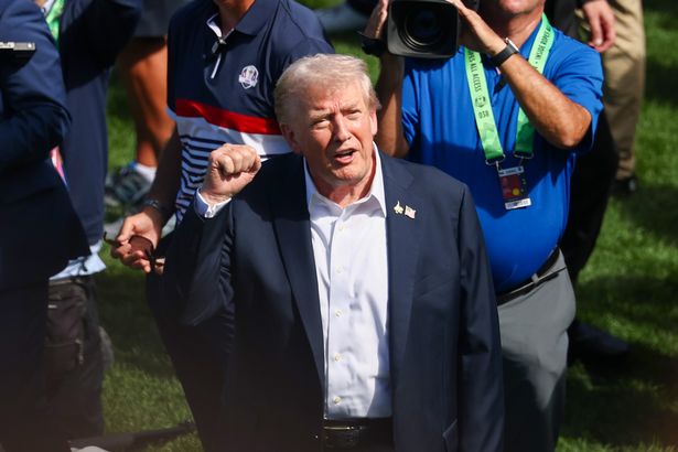 FARMINGDALE, NEW YORK - SEPTEMBER 26: United States President Donald Trump acknowledges the crowd at the first hole tee box during the Friday afternoon four-ball matches of the 2025 Ryder Cup at Black Course at Bethpage State Park Golf Course on September 26, 2025 in Farmingdale, New York. (Photo by Jared C. Tilton/Getty Images)