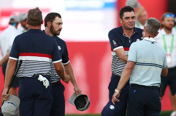 Captain Keegan Bradley of Team United States shakes hands with Captain Luke Donald