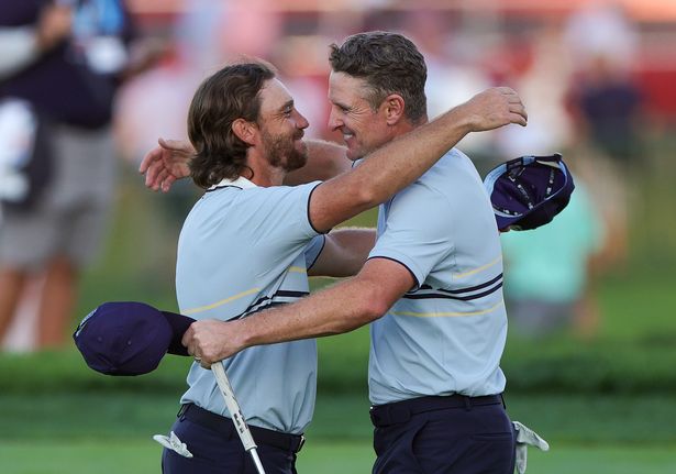 Tommy Fleetwood of Team Europe celebrates with team-mate Justin Rose on the 18th hole green