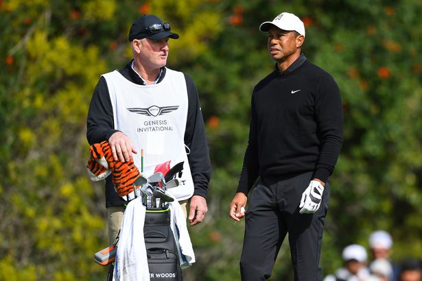 Joe LaCava caddying for Tiger Woods
