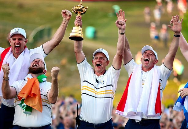 Europe captain Luke Donald lifts the Ryder Cup alongside Shane Lowry and Rory McIlroy
