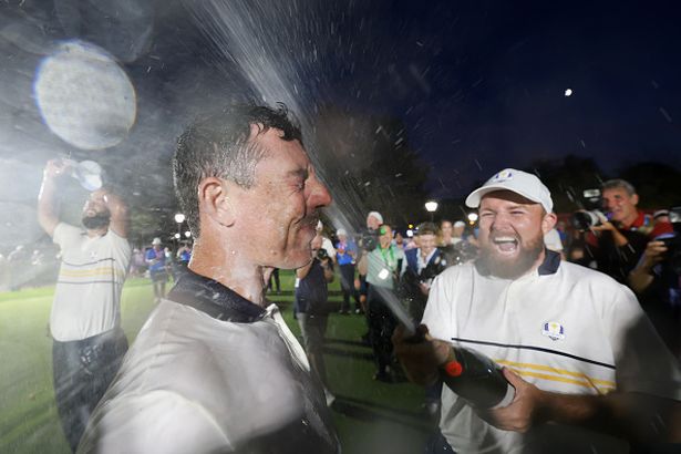 Rory McIlroy of Team Europe is doused with champagne as teammate Shane Lowry reacts after Team Europe defeated Team United States 15-13 