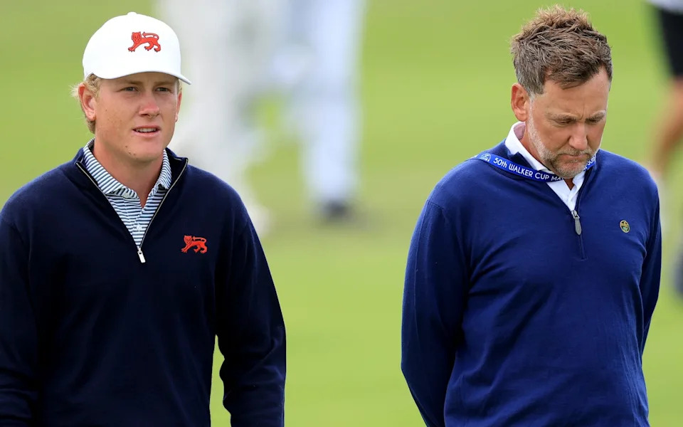 Luke Poulter of England and The Great Britain and Ireland Team walks with his father Ian Poulter
