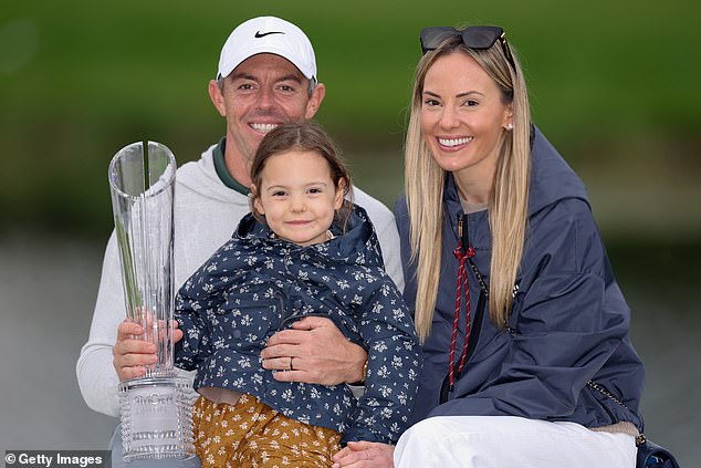 The Northern Irishman celebrates his victory with his wife Erica and daughter Poppy