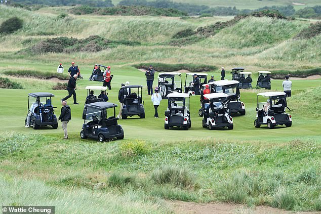 Mr Trump was surrounded by security and staff in golf buggies when he played the course