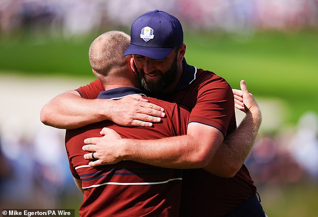 The Spaniard and teammate Tyrrell Hatton share a hug after winning their foursomes match