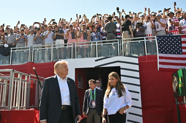 President Donald Trump, along with his granddaughter Kai Madison Trump, attends the 2025 Ryder Cup at Black Course at Bethpage State Park Golf Course on September 26, 2025 in Farmingdale, New York. In his second term, Trump has attended several major sporting events.  