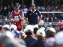 Scottie Scheffler of Team United States and caddie Ted Scott look on from the ninth green during the Saturday morning foursomes matches of the 2025 Ryder Cup at Black Course at Bethpage State Park Golf Course on September 27, 2025 in Farmingdale, New York.