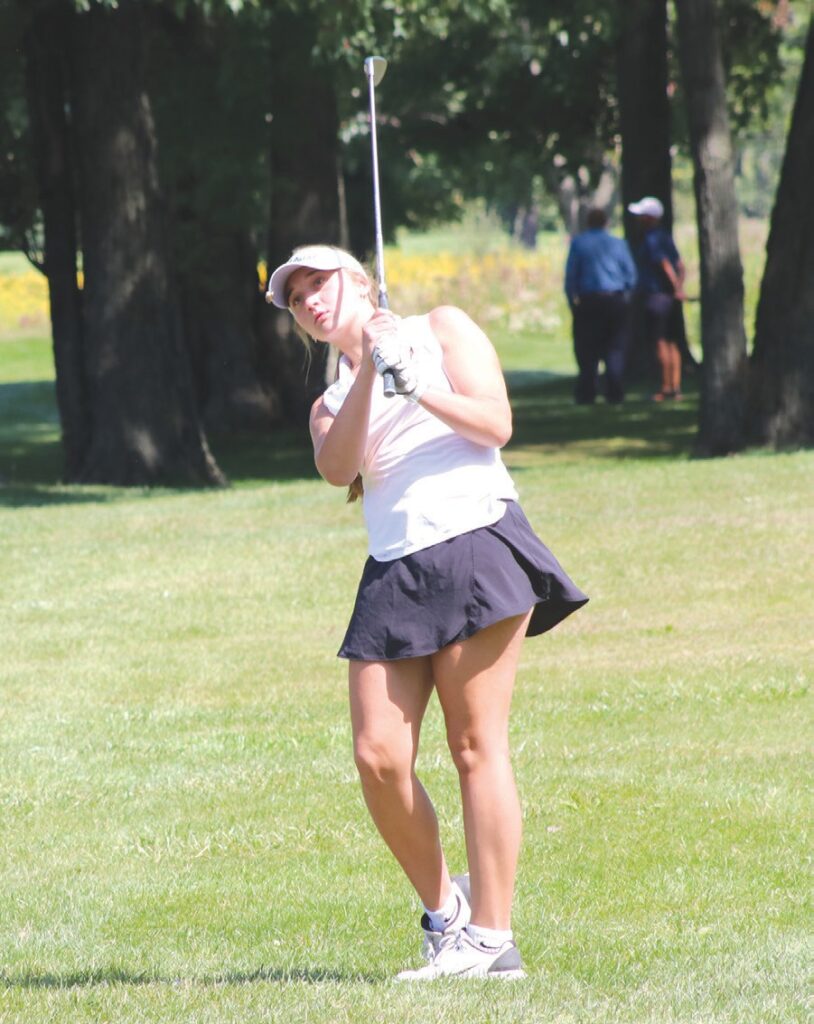 Almont’s Noelle Bourdeau takes a few practice swings before hitting from the Fairway at Castle Creek Golf Course on Sept. 8.