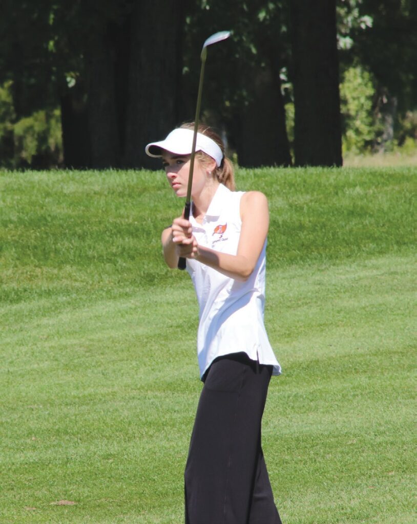 Almont’s Liv Moussiaux chips a shot onto the green to finish out the front nine at Castle Creek on Sept. 8.