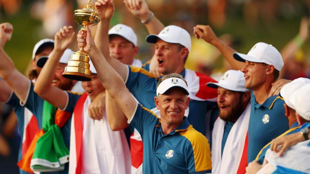 Luke Donald lifting the 2023 Ryder Cup trophy