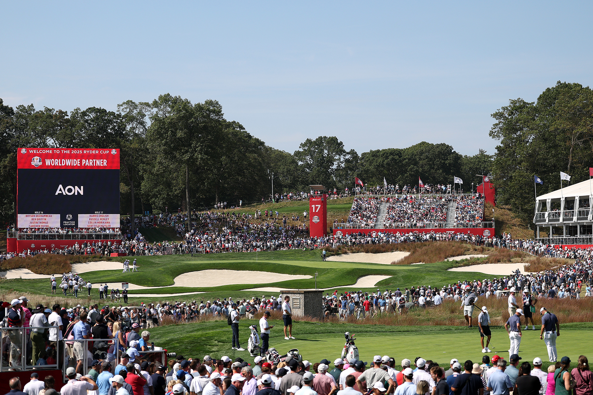 The crowds gathered around the 17th hole at Bethpage Black, host venue of the 2025 Ryder Cup, with grandstands and large bunkers surrounding the green
