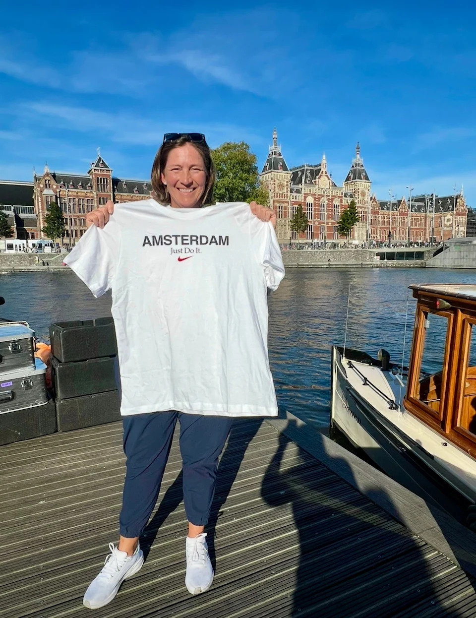 Angela Stanford holds up her souvenir T-shirt from Amsterdam, which she purchased earlier this month after her bags didn't arrive.