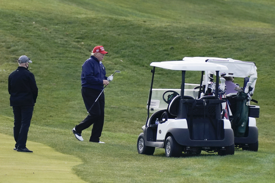 President Donald Trump walking back to golf cart as he plays golf at Trump National Golf Club in Sterling, Va., Sunday, Dec. 13, 2020. (AP Photo/Manuel Balce Ceneta)