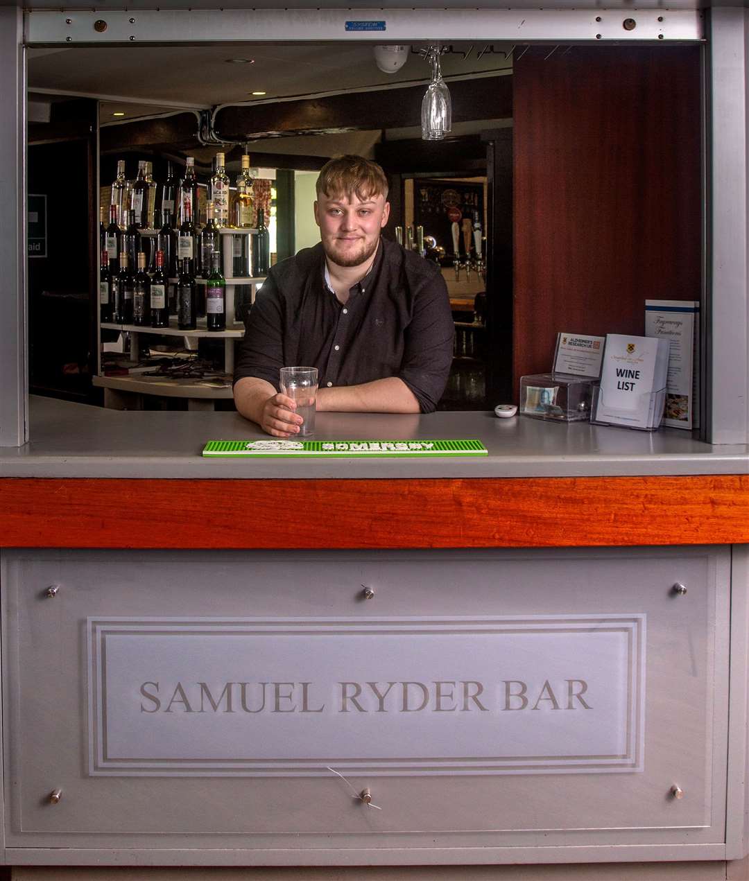 Above right, Samuel Ryder and, right, his name on the captains’ board. Above, barman Harvey Errington at the Samuel Ryder Bar. Photo: Mark Williamson